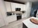 Well-equipped kitchen with stainless steel appliances, white cabinets and stylish countertop at 14963 Yorkshire Run Dr, Orlando, FL 32828