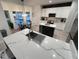 Bright kitchen featuring white cabinets, stainless appliances, an eat-in area with an island, and pendant lighting at 14963 Yorkshire Run Dr, Orlando, FL 32828