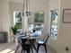 Kitchen nook with round table and seating overlooking the pool through bright windows at 14963 Yorkshire Run Dr, Orlando, FL 32828