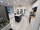Open-concept kitchen showcasing white cabinets, stainless appliances, and a view of the dining nook at 14963 Yorkshire Run Dr, Orlando, FL 32828