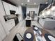 Bright kitchen featuring stainless steel appliances, stone countertops, white cabinets, and island with dark wood accents at 14963 Yorkshire Run Dr, Orlando, FL 32828