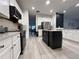 Well-lit kitchen featuring white cabinets, stainless steel appliances, and a stylish center island at 14963 Yorkshire Run Dr, Orlando, FL 32828