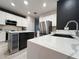 Modern kitchen featuring white cabinets, marble countertops, stainless steel appliances, and a wine cooler at 14963 Yorkshire Run Dr, Orlando, FL 32828