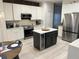 Modern kitchen boasting sleek white cabinetry, stainless steel appliances, and a chic island at 14963 Yorkshire Run Dr, Orlando, FL 32828