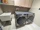 Bright laundry room featuring Samsung washer and dryer and cabinet space at 14963 Yorkshire Run Dr, Orlando, FL 32828