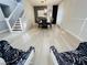 Open-concept living room with hardwood floors, a staircase, and a dining area with modern decor and neutral colors at 14963 Yorkshire Run Dr, Orlando, FL 32828
