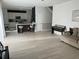 Bright and open living space merging with a modern kitchen, featuring tile flooring and bright neutral walls at 14963 Yorkshire Run Dr, Orlando, FL 32828