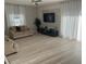 Inviting living room features a media center, neutral toned couches, large windows, and curtains for a bright atmosphere at 14963 Yorkshire Run Dr, Orlando, FL 32828