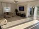 Bright living room with a television, tile accent wall, window, sliding glass door and comfortable seating arrangements at 14963 Yorkshire Run Dr, Orlando, FL 32828