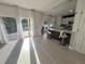 Open living room showcasing light wood floors, sliding glass doors, and a kitchen island with stools at 14963 Yorkshire Run Dr, Orlando, FL 32828