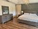 Inviting main bedroom featuring a wooden dresser and a wooden bedframe with light wood floors at 14963 Yorkshire Run Dr, Orlando, FL 32828