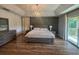 Spacious main bedroom featuring wood floors, tray ceilings, and a walk-out balcony at 14963 Yorkshire Run Dr, Orlando, FL 32828