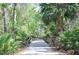A peaceful walking path through a lush wooded area, ideal for nature walks and outdoor exercise at 14963 Yorkshire Run Dr, Orlando, FL 32828