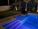 Beautifully lit in-ground pool, complemented by tropical landscaping creating a serene backyard oasis at 14963 Yorkshire Run Dr, Orlando, FL 32828