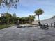 Backyard pool area with pavers, palm trees, and comfortable lounge chairs for relaxing at 14963 Yorkshire Run Dr, Orlando, FL 32828