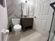 Stylish powder room featuring modern vanity, updated mirror, and chic wall design at 14963 Yorkshire Run Dr, Orlando, FL 32828