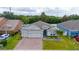 Charming single-story home featuring a brick driveway, a well-manicured lawn and a two-car garage at 1557 Alligator St, St Cloud, FL 34771