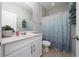 Bathroom with a single sink vanity and shower and tub combination with blue accents at 1557 Alligator St, St Cloud, FL 34771