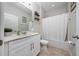 Clean bathroom features a tub-shower combo, white vanity, and neutral flooring at 1557 Alligator St, St Cloud, FL 34771