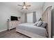 Comfortable bedroom featuring stylish furniture, wood floors, and a ceiling fan at 1557 Alligator St, St Cloud, FL 34771
