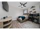 Stylish bedroom featuring wood-look floors, a ceiling fan, and a dedicated gaming space at 1557 Alligator St, St Cloud, FL 34771