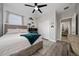This bedroom features wood-look floors, a ceiling fan, and a dedicated gaming space at 1557 Alligator St, St Cloud, FL 34771