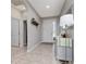 Inviting foyer features tile flooring, neutral paint colors and a light gray console table at 1557 Alligator St, St Cloud, FL 34771