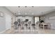 Bright kitchen with bar stool seating, white cabinets, stainless appliances, and views to dining and living areas at 1557 Alligator St, St Cloud, FL 34771