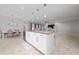 Open-concept kitchen with a large island, stainless steel appliances, and a view into the dining and living areas at 1557 Alligator St, St Cloud, FL 34771