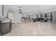 Spacious living room with tile flooring, a ceiling fan, and seamless transition into the kitchen and dining areas at 1557 Alligator St, St Cloud, FL 34771