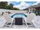 Relax by the sparkling pool, accented by an outdoor patio area with white lounge chairs at 1557 Alligator St, St Cloud, FL 34771