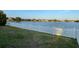 Backyard lawn with white picket fence offering lake views creates a serene outdoor oasis at 1574 Thetford Cir, Orlando, FL 32824