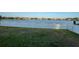 Lawn with white picket fence offers scenic lake view, perfect for relaxation and outdoor enjoyment at 1574 Thetford Cir, Orlando, FL 32824