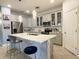 Bright kitchen featuring marble countertops, updated appliances, and seating at the island at 1574 Thetford Cir, Orlando, FL 32824