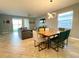 Spacious living area with a dining table, comfortable seating, and serene views from large windows at 1574 Thetford Cir, Orlando, FL 32824