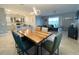 Inviting open-concept living area with dining table, kitchen in the background, and ample natural light at 1574 Thetford Cir, Orlando, FL 32824