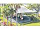 Community playground featuring slides, shade structure, and lush landscaping at 1574 Thetford Cir, Orlando, FL 32824