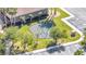 An aerial view of a playground featuring swings, climbing apparatus, and grassy surroundings at 1574 Thetford Cir, Orlando, FL 32824