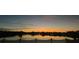 Scenic sunset view over a tranquil lake, creating a picturesque and serene setting at 1574 Thetford Cir, Orlando, FL 32824