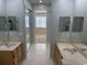 Spacious primary bath with double sinks, tile flooring, and separate vanities at 15851 Woodland Spring Ct, Orlando, FL 32828