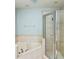 Bathroom featuring a shower and soaking tub with tile surround at 15851 Woodland Spring Ct, Orlando, FL 32828