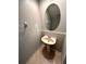 Small bathroom with pedestal sink, decorative mirror, tile floor and neutral paint at 15851 Woodland Spring Ct, Orlando, FL 32828