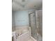 Bathroom with walk-in shower, soaking tub with neutral tile, and recessed lighting at 15851 Woodland Spring Ct, Orlando, FL 32828