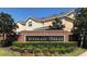 Well-maintained Woodland Terrace community sign with colorful landscaping and beautiful townhomes in the background at 15851 Woodland Spring Ct, Orlando, FL 32828