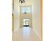 Open foyer featuring tile floor, high ceilings, statement lighting, and waterfront view at 15851 Woodland Spring Ct, Orlando, FL 32828