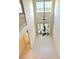 Bright, tall foyer with lots of natural light and a hanging chandelier, tiled floor and transom window at 15851 Woodland Spring Ct, Orlando, FL 32828