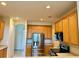 Kitchen with stainless steel appliances and light wood cabinetry at 15851 Woodland Spring Ct, Orlando, FL 32828