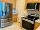 Close up of modern stainless steel appliances and light wood cabinets in kitchen at 15851 Woodland Spring Ct, Orlando, FL 32828