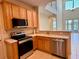 Modern kitchen with stainless steel appliances and quartz countertops at 15851 Woodland Spring Ct, Orlando, FL 32828