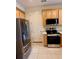 Stainless steel appliances and wood cabinets in this well-equipped kitchen at 15851 Woodland Spring Ct, Orlando, FL 32828